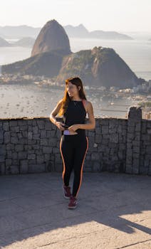 Woman in sportswear enjoys morning view from Mirante Dona Marta, Rio de Janeiro.